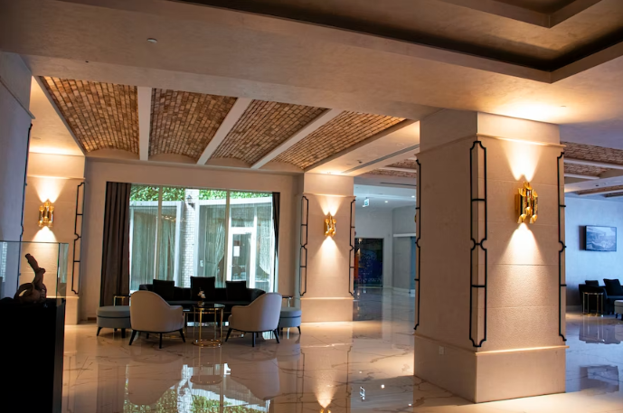 A large dining hall in a beautiful house with great lighting.