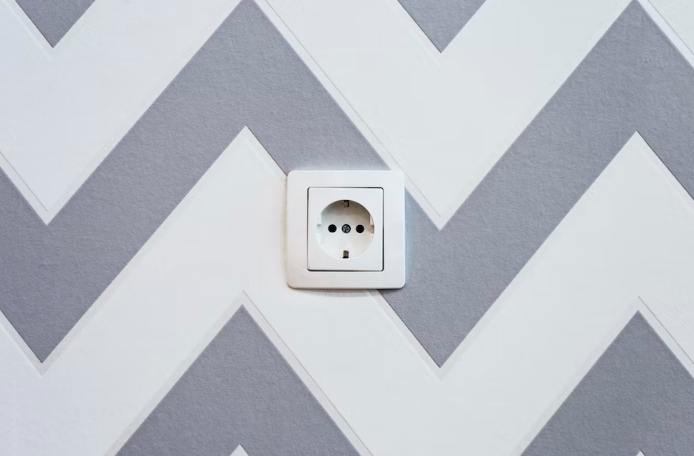 An electrical outlet placed on a painted wall.