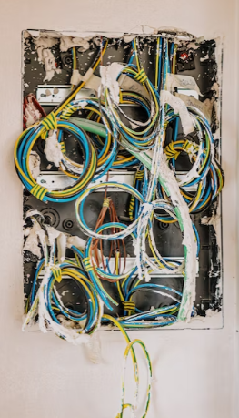 Several different-colored wires are left open and unprotected.